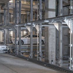 The car is being parked in an automated parking system.