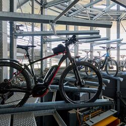 A bicycle on a rail in an automated bicycle parking system