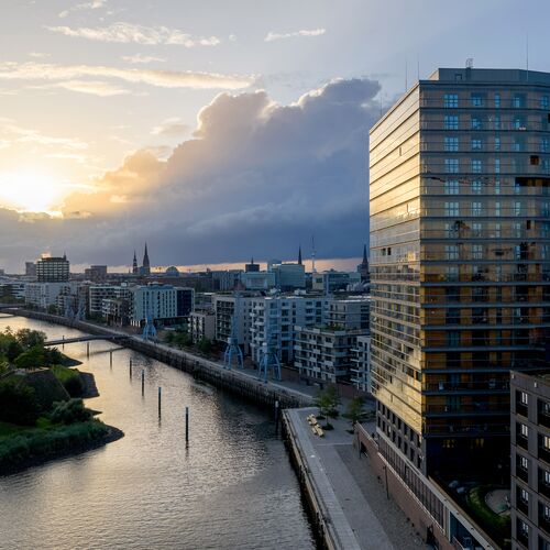 Exterior view of the Roots skyscraper in HafenCity at dusk