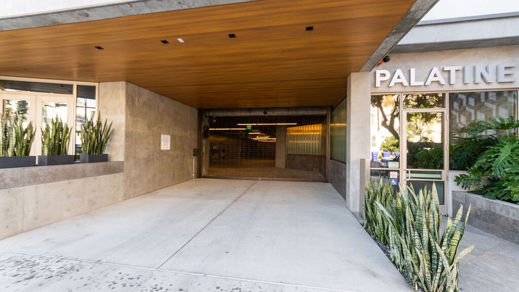 Modern entrance to a residential building with an integrated parking system.