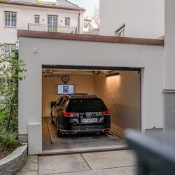 The car is parked in the garage entrance