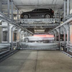 The car is parked on a parking platform within an automated parking system.